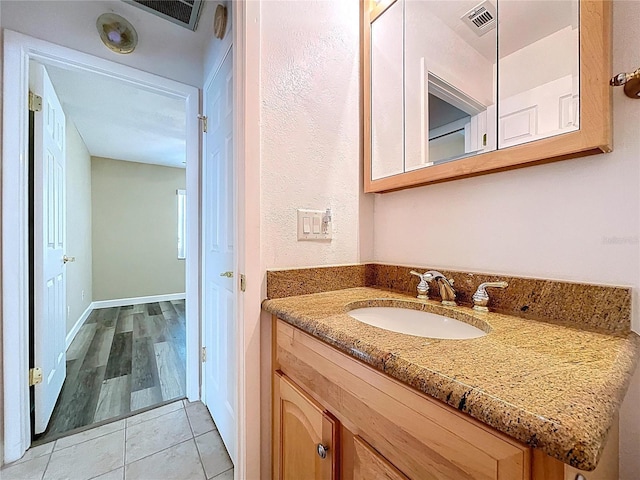 bathroom featuring tile patterned floors, vanity, and visible vents