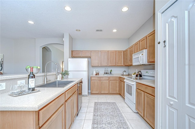 16501 Sandhill Crane Dr, Spring Hill, FL 34610 - kitchen with white appliances, a sink, light brown cabinets, light tile patterned floors, and recessed lighting
