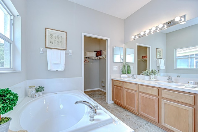 16501 Sandhill Crane Dr, Spring Hill, FL 34610 - full bathroom featuring plenty of natural light, a garden tub, double vanity, and a walk in closet