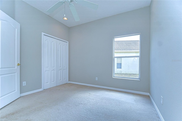 16501 Sandhill Crane Dr, Spring Hill, FL 34610 - unfurnished bedroom with carpet flooring, a closet, baseboards, and a ceiling fan
