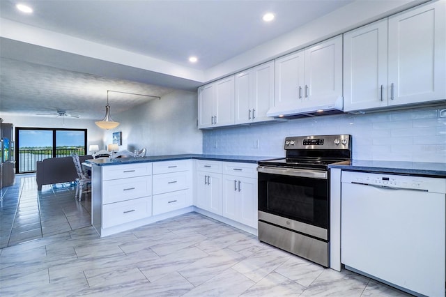 kitchen with dark countertops, white dishwasher, under cabinet range hood, electric range, and a peninsula