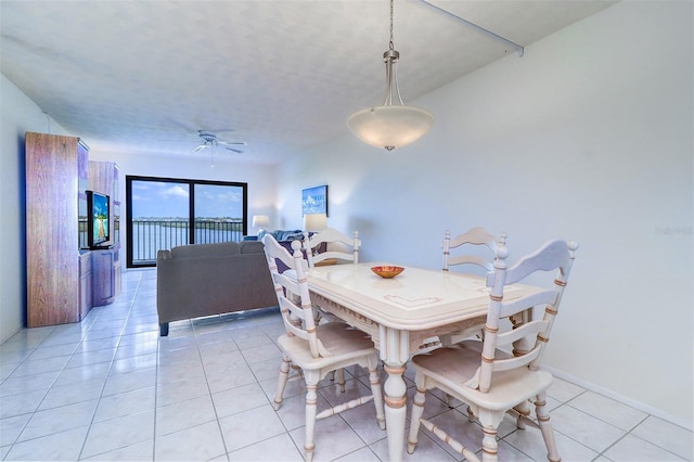 dining room featuring light tile patterned floors, ceiling fan, and baseboards