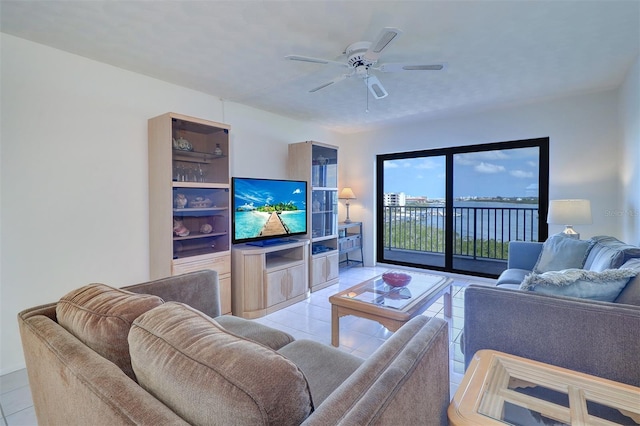 living area with light tile patterned floors and a ceiling fan