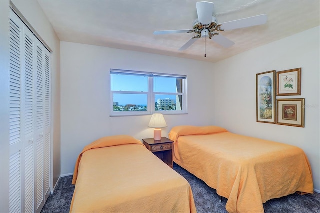 bedroom featuring a closet, ceiling fan, and carpet