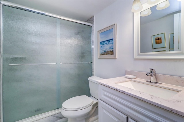 full bathroom featuring vanity, toilet, and a stall shower