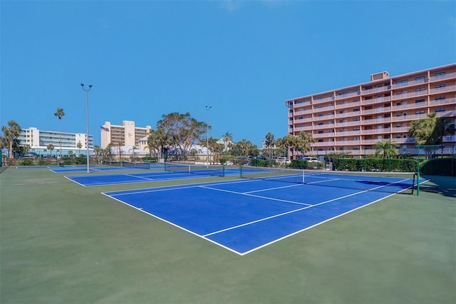 view of tennis court with fence and community basketball court