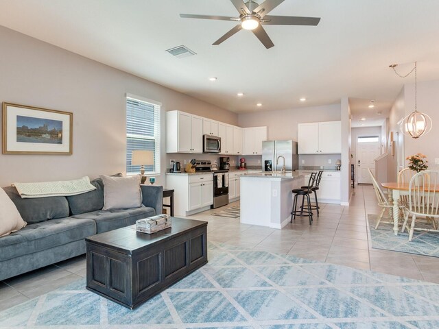 living room featuring recessed lighting, visible vents, ceiling fan, and light tile patterned floors