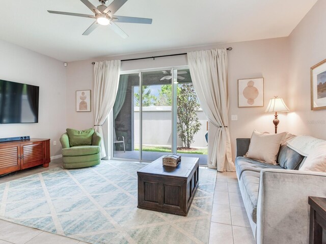 living area with light tile patterned floors and ceiling fan