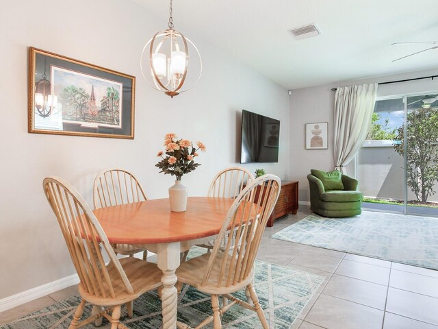 dining space with baseboards, visible vents, a chandelier, and light tile patterned floors