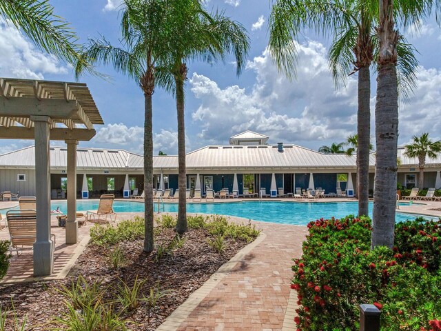 community pool featuring a pergola
