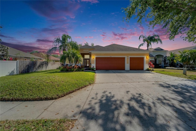view of front of property with an attached garage, stucco siding, and driveway