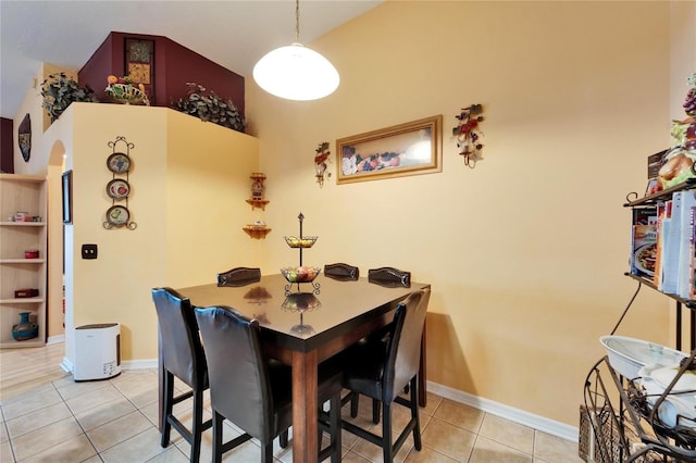 dining area with light tile patterned floors and baseboards