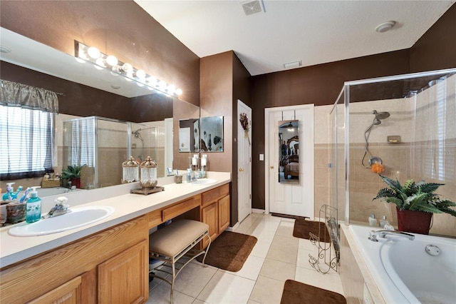 bathroom featuring a stall shower, a garden tub, tile patterned flooring, and double vanity
