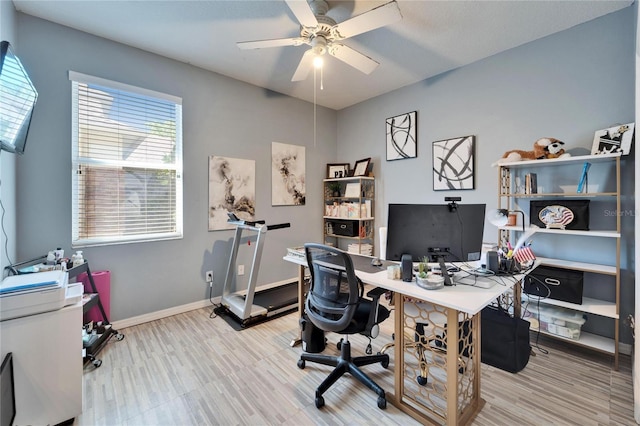 office area featuring ceiling fan, baseboards, and wood finished floors
