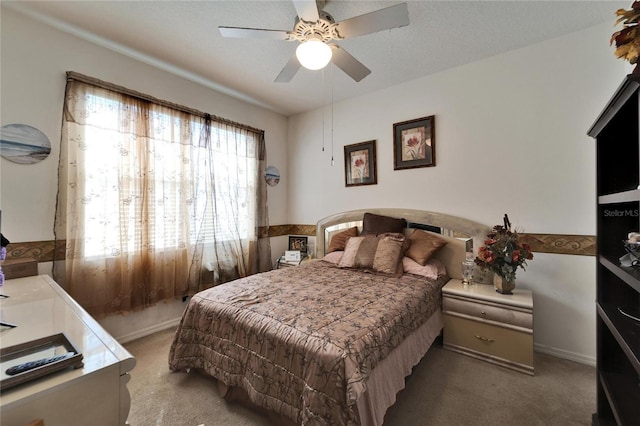 bedroom featuring carpet flooring, a ceiling fan, and baseboards
