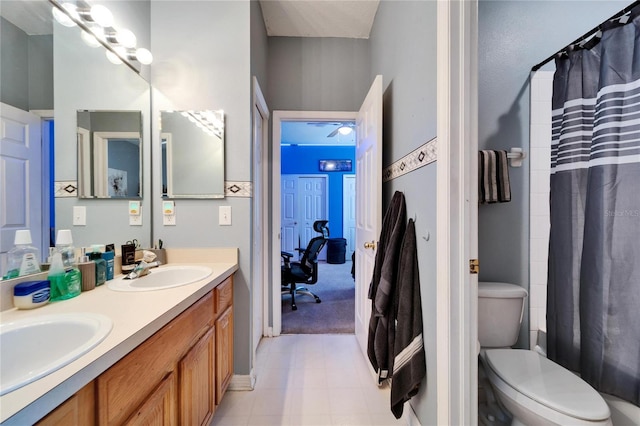 full bathroom with double vanity and toilet