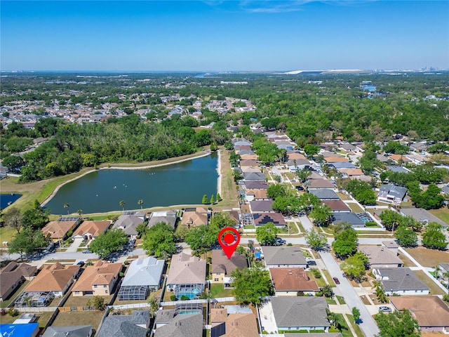 aerial view of property's location featuring a nearby body of water and nearby suburban area