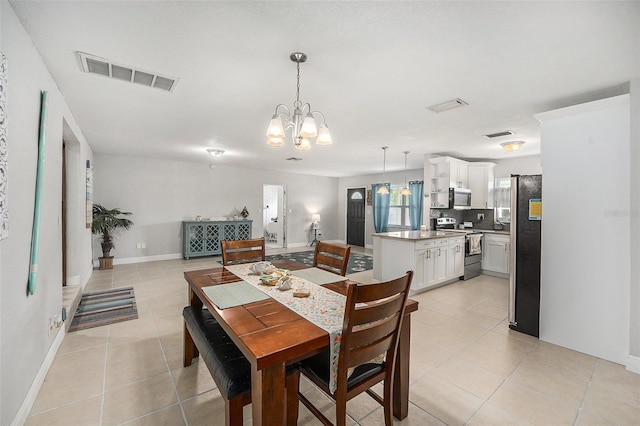 831 72nd Ave N, Saint Petersburg, FL 33702 - dining room featuring a chandelier, light tile patterned floors, and visible vents