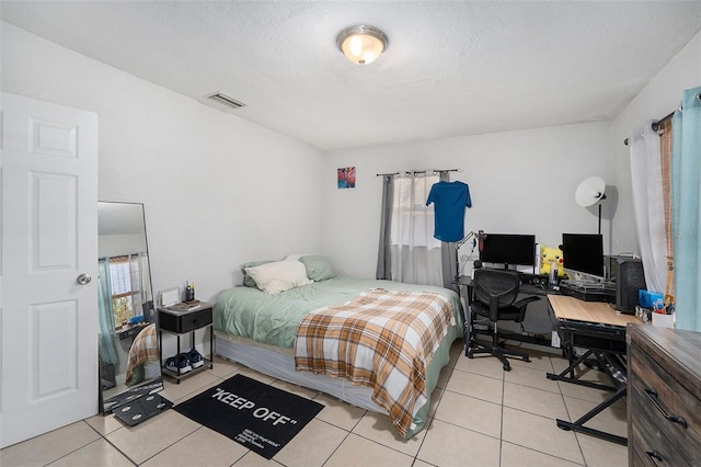 831 72nd Ave N, Saint Petersburg, FL 33702 - bedroom featuring visible vents, multiple windows, light tile patterned floors, and a textured ceiling