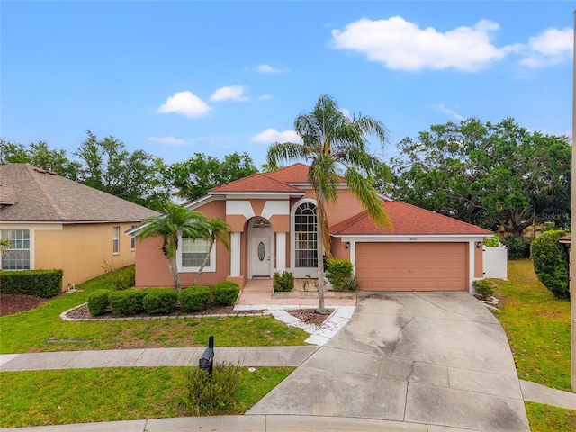 18005 Palm Breeze Dr, Tampa, FL 33647 - mediterranean / spanish house with a garage, a front yard, driveway, and stucco siding