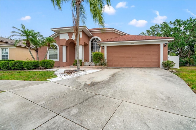 18005 Palm Breeze Dr, Tampa, FL 33647 - mediterranean / spanish home with driveway, stucco siding, and an attached garage