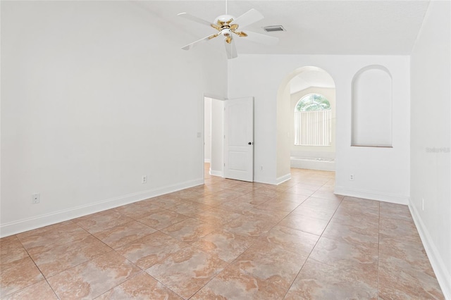 18005 Palm Breeze Dr, Tampa, FL 33647 - spare room with ceiling fan, arched walkways, visible vents, lofted ceiling, and baseboards