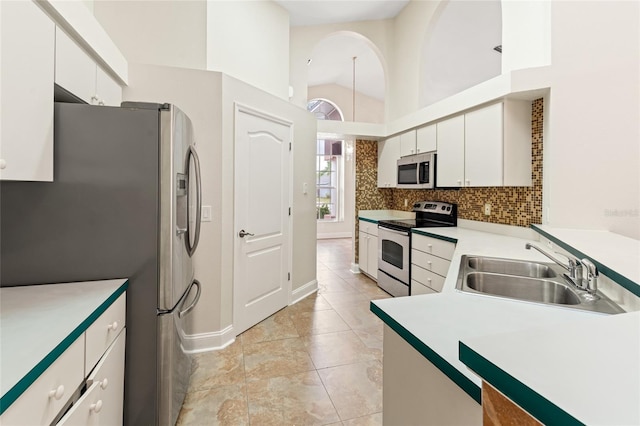 18005 Palm Breeze Dr, Tampa, FL 33647 - kitchen with light countertops, white cabinetry, backsplash, stainless steel appliances, and a sink