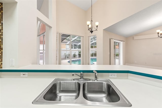 18005 Palm Breeze Dr, Tampa, FL 33647 - kitchen featuring light countertops, pendant lighting, an inviting chandelier, and a sink