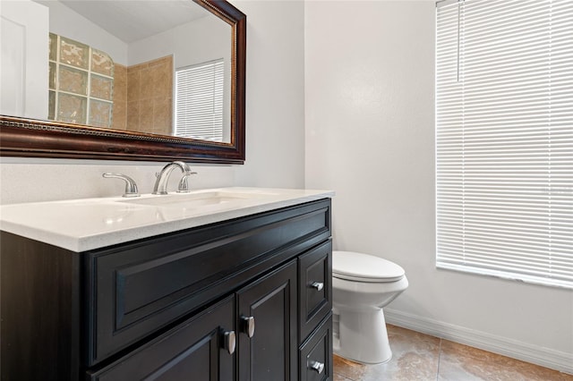 18005 Palm Breeze Dr, Tampa, FL 33647 - full bath with vanity, baseboards, and toilet