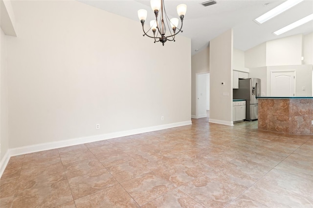 18005 Palm Breeze Dr, Tampa, FL 33647 - spare room with high vaulted ceiling, a notable chandelier, baseboards, and visible vents