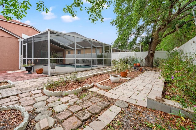 18005 Palm Breeze Dr, Tampa, FL 33647 - view of yard featuring a patio area, a fenced backyard, glass enclosure, and a fenced in pool