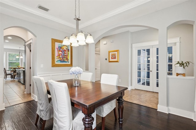 dining room featuring dark wood finished floors, arched walkways, visible vents, a chandelier, and french doors