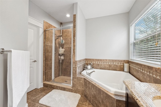 bathroom featuring a shower stall, tile patterned flooring, vanity, and a garden tub