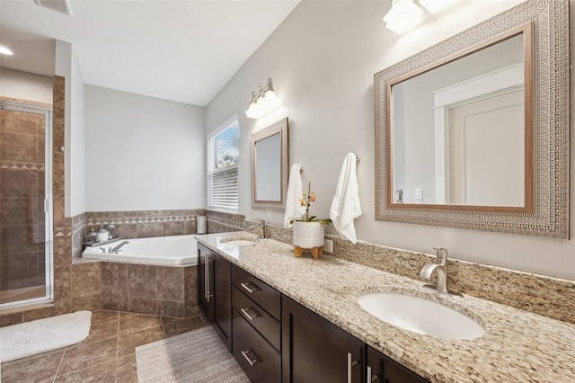 full bathroom featuring a sink, tile patterned floors, a shower stall, and a garden tub