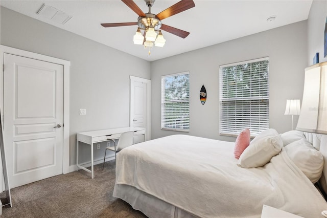 bedroom with visible vents, a ceiling fan, and carpet flooring