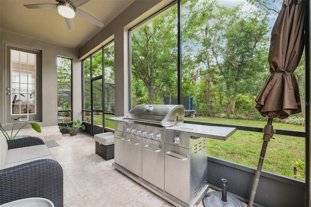 sunroom / solarium featuring ceiling fan