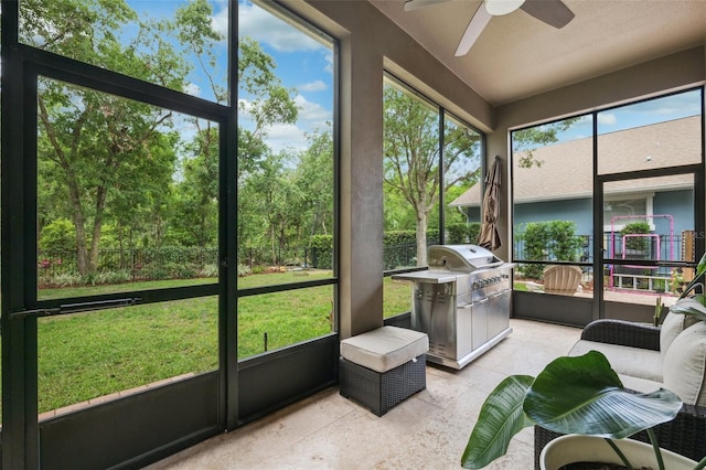 sunroom / solarium featuring ceiling fan