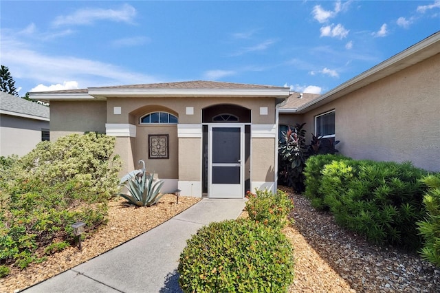 property entrance featuring stucco siding