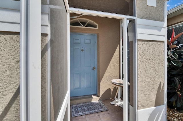 property entrance with stucco siding
