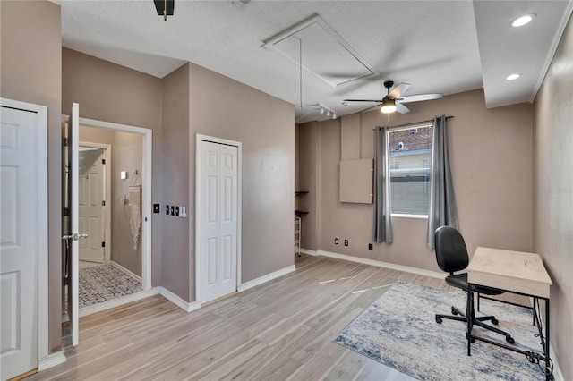 office area with a ceiling fan, recessed lighting, attic access, baseboards, and light wood finished floors