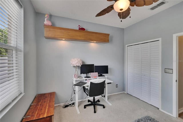 carpeted office with baseboards, a ceiling fan, and visible vents
