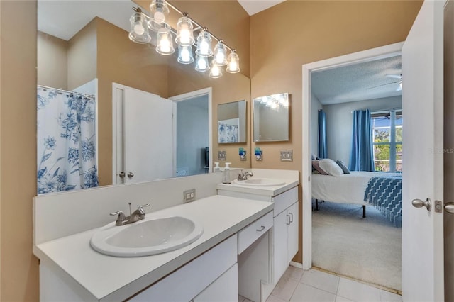 full bath featuring tile patterned flooring, connected bathroom, double vanity, and a sink