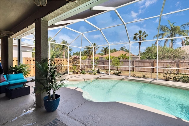 view of swimming pool with glass enclosure, a patio, a fenced in pool, and a fenced backyard
