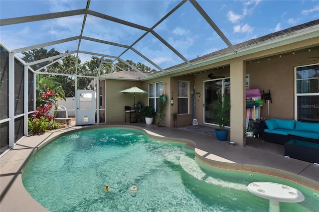outdoor pool featuring ceiling fan, a patio area, a lanai, and an outdoor hangout area