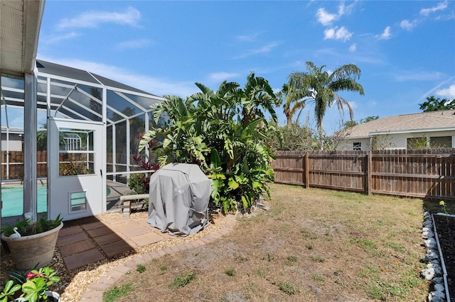 view of yard with a patio area, a lanai, a fenced in pool, and a fenced backyard