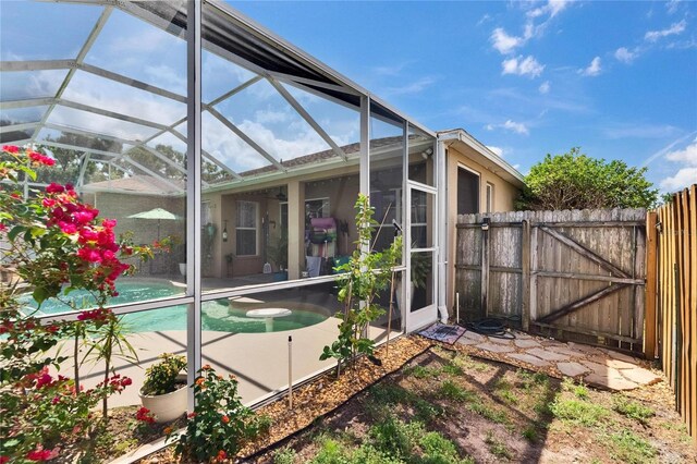 exterior space featuring a fenced backyard, a lanai, a fenced in pool, and a patio area