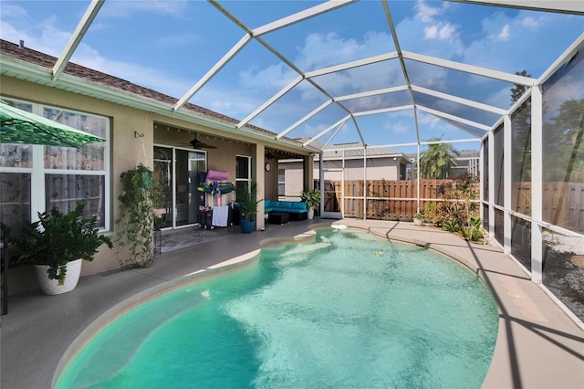 view of swimming pool featuring a patio area, fence, a lanai, ceiling fan, and a fenced in pool