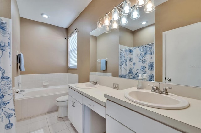bathroom featuring a bath, tile patterned flooring, double vanity, and a sink