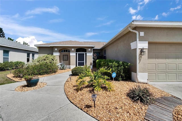 ranch-style home with stucco siding and an attached garage
