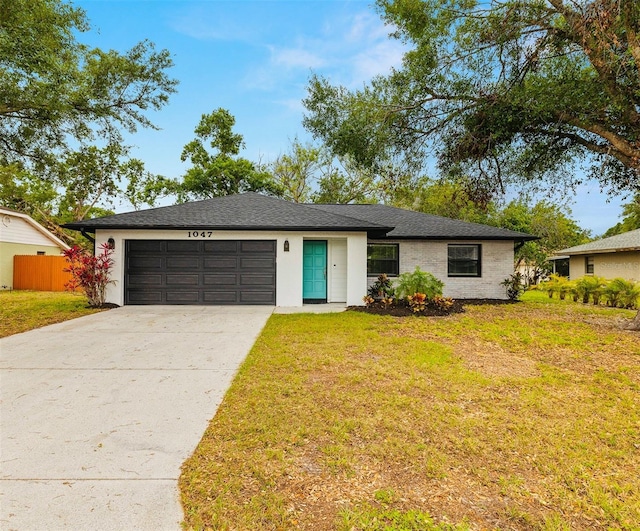 1047 Deer Hollow Way, Sarasota, FL 34232 - ranch-style home featuring a garage, driveway, a front yard, and fence